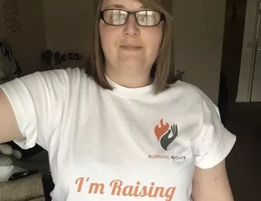 Lady with brown hair wearing white t-shirt