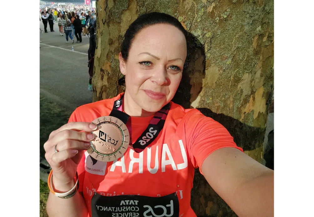 Laura with her medal after running the London Marathon