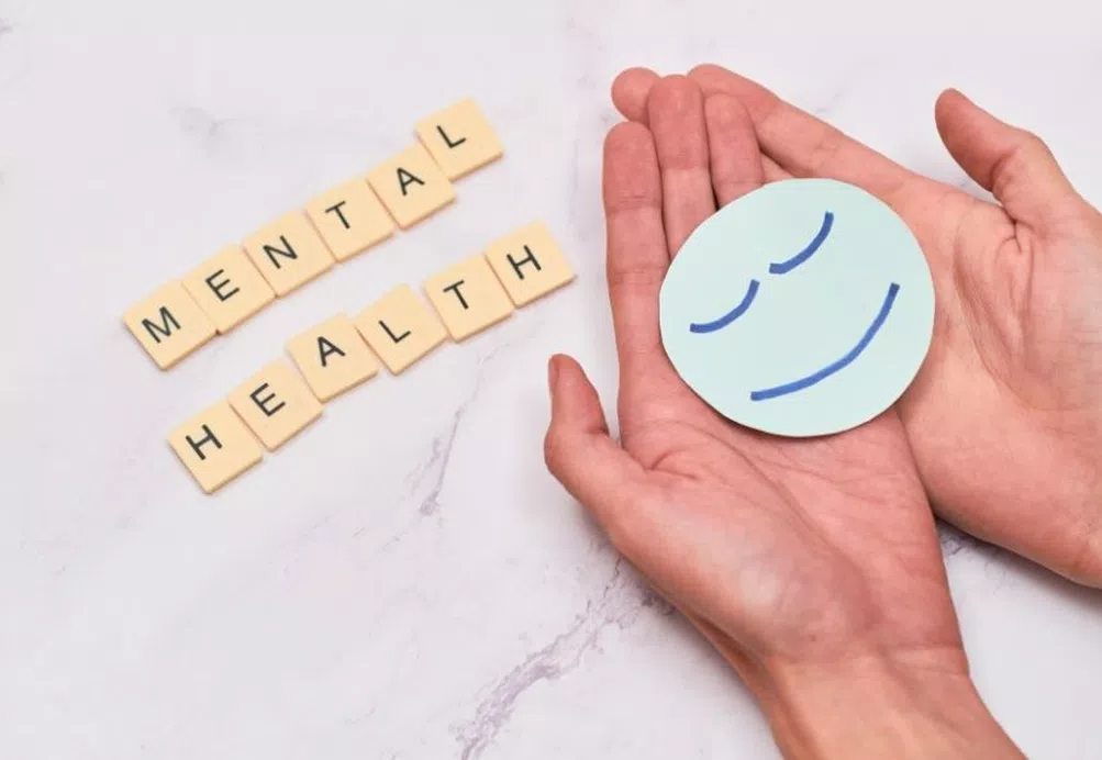 Using scramble to spell the words mental health on the top, with a sad face at the bottom