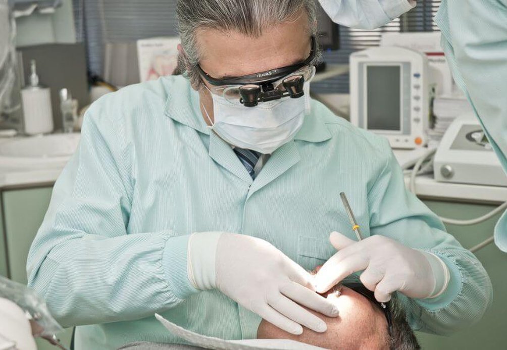 Dentist examines patient