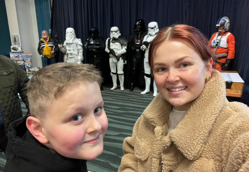 The image shows Maddie with her brother Dillon at a museum outing together