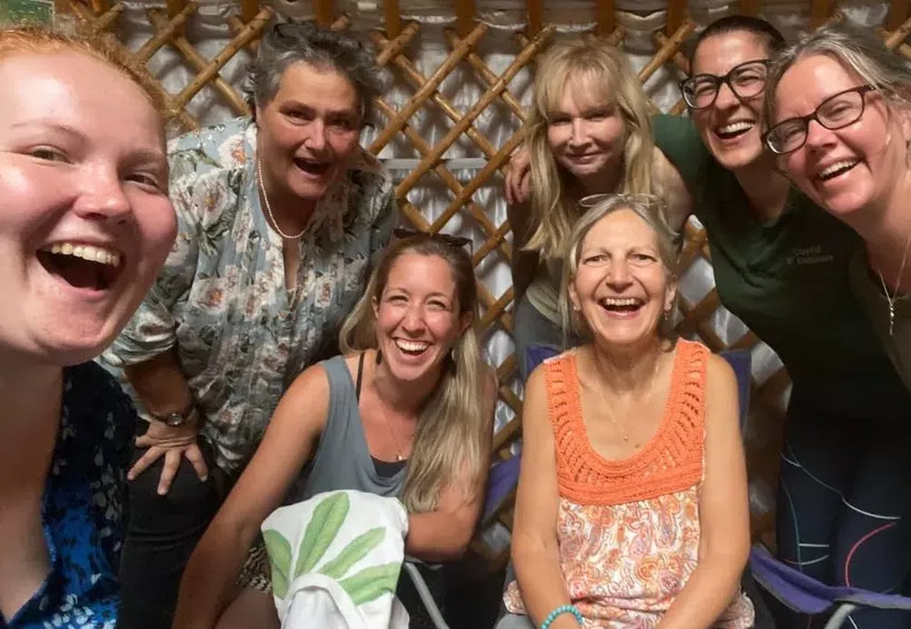 A group of women laughing together.