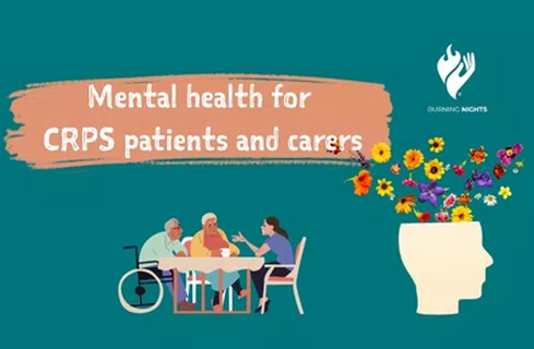 elderly patients and carers sitting at the table, with flowers next to it