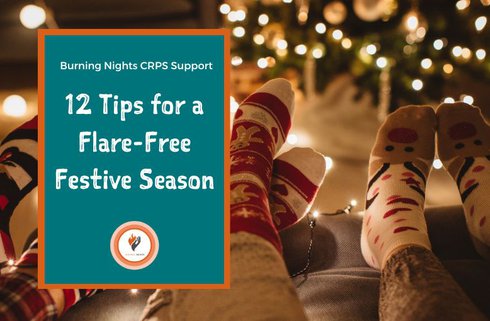 12 tips for a flare-free festive season by Burning Nights CRPS Support. Three friends wearing cosy Christmas socks relax in front of a Christmas tree.