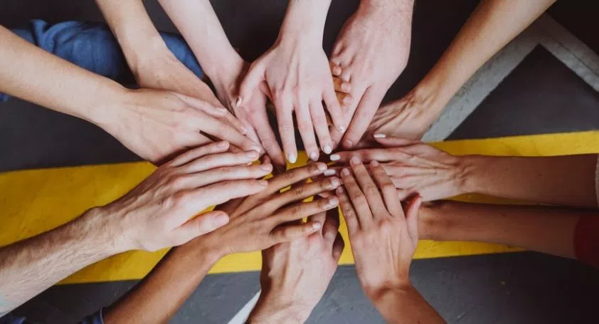 Many hands coming together to support each other