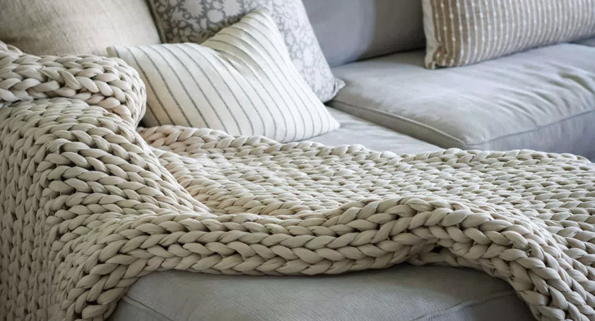 Image of a large weighted blanket on top of a sofa
