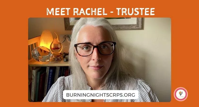 White woman with grey and white hair smiling