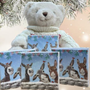 Card with three donkeys together smiling with a winter snowy background in blue