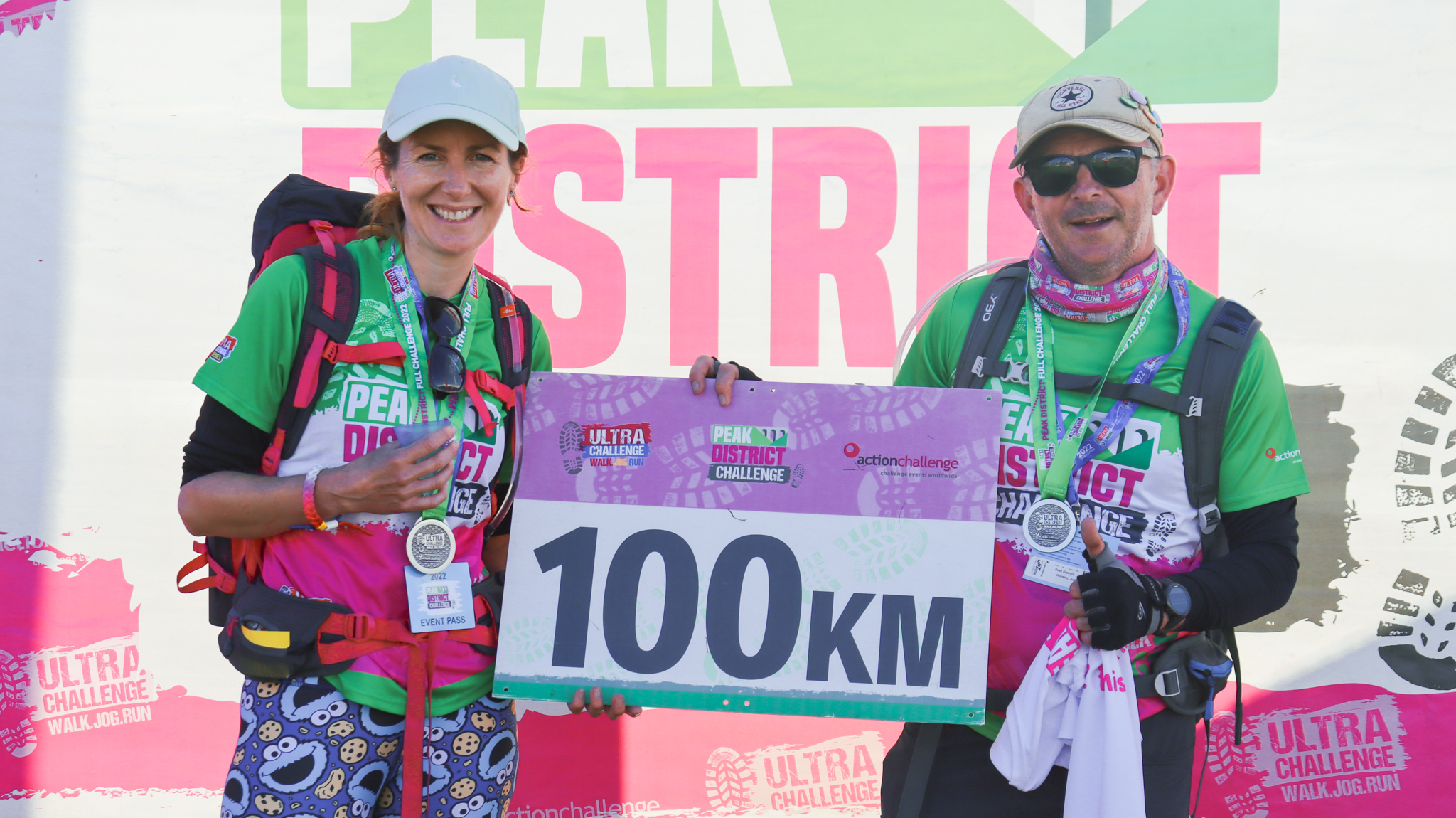 Peak District Ultra Challenge 2026, photo of participants in their finisher medals with a sign that says "100km"