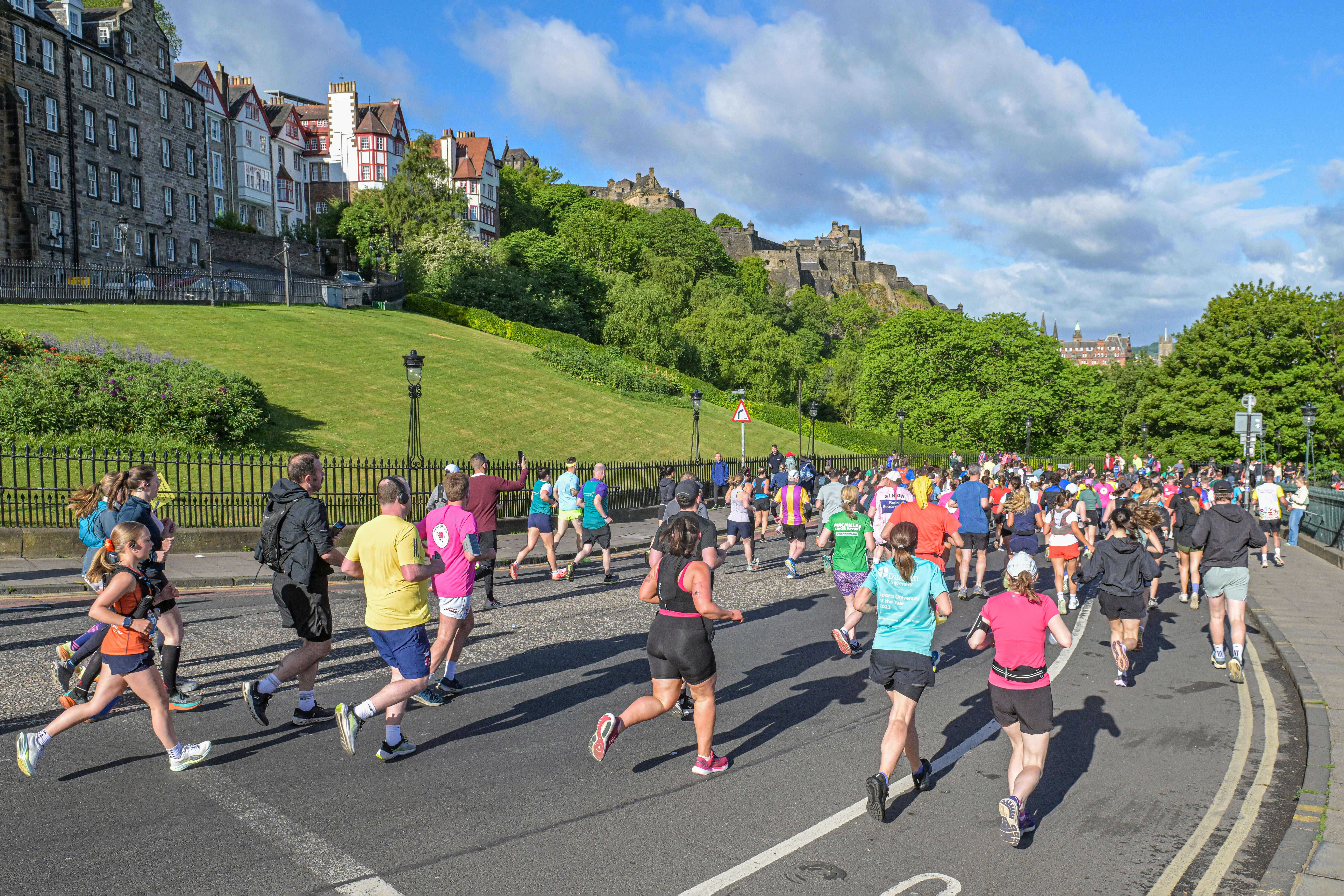 2026 Edinburgh Marathon Festival, photo of event participants running along the route in the city centre on a sunny day