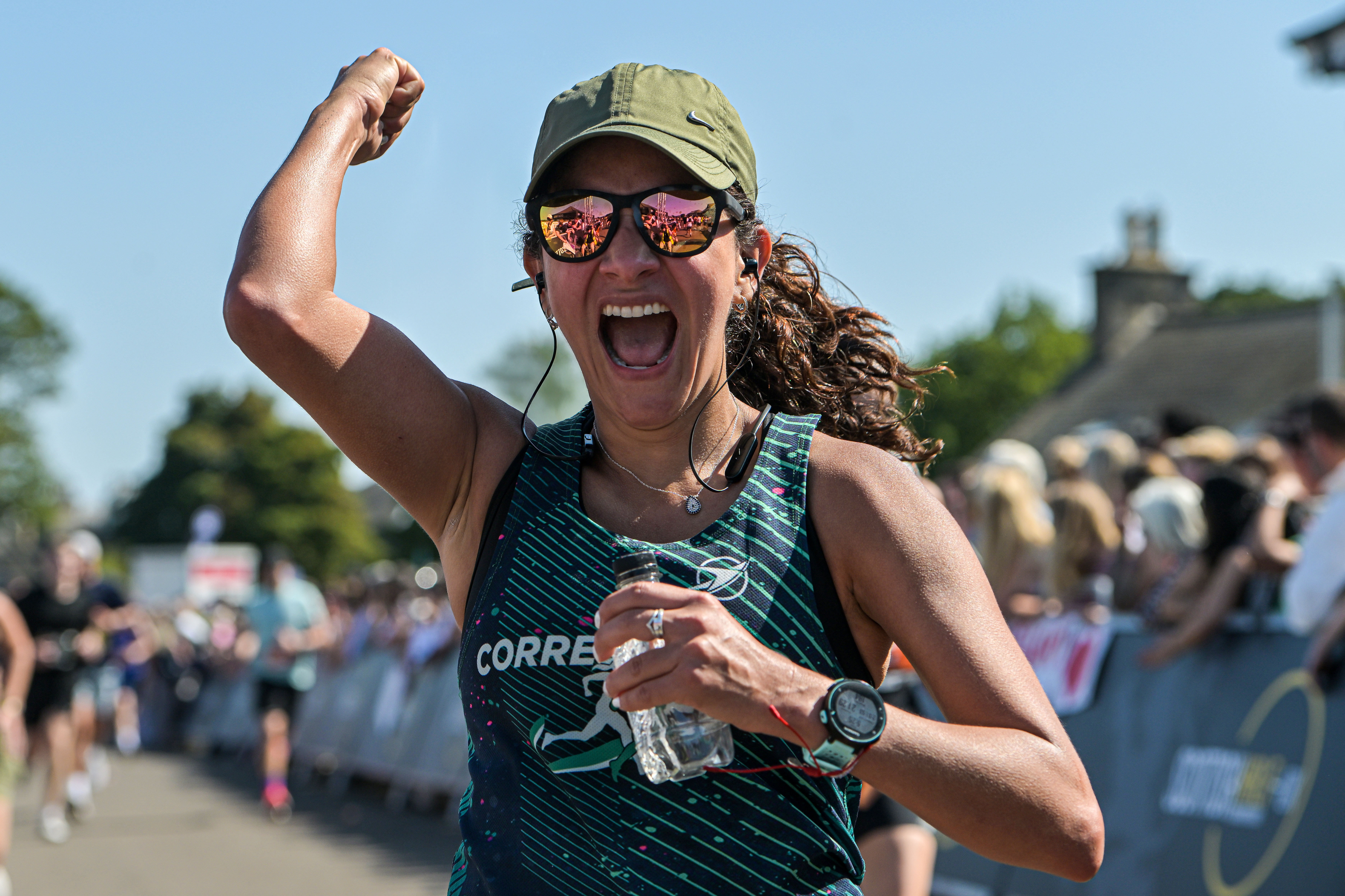 2026 Scottish Half Marathon, photo of event participant wearing sunglasses and a cap, smiling and punching the air