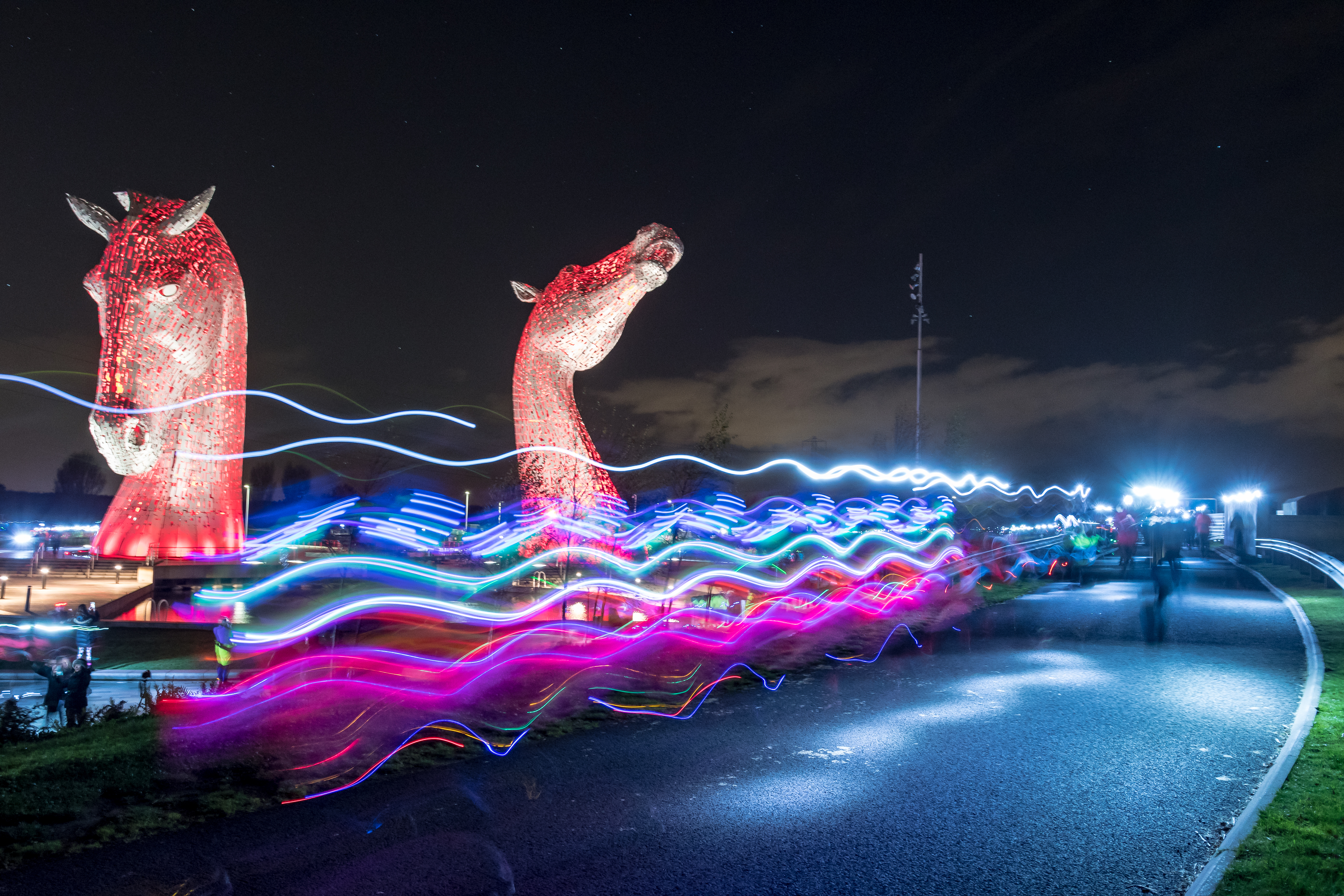 2026 Supernova Kelpies Run, photo of the Kelpies illuminated at night with long exposure of the event participants' lights running past